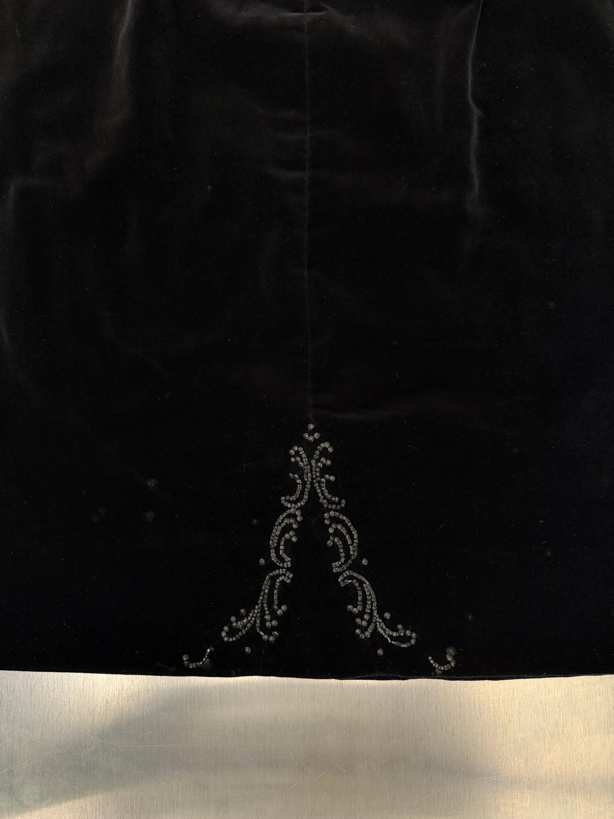 close-up of the beaded filigree motif on the black velvet skirt