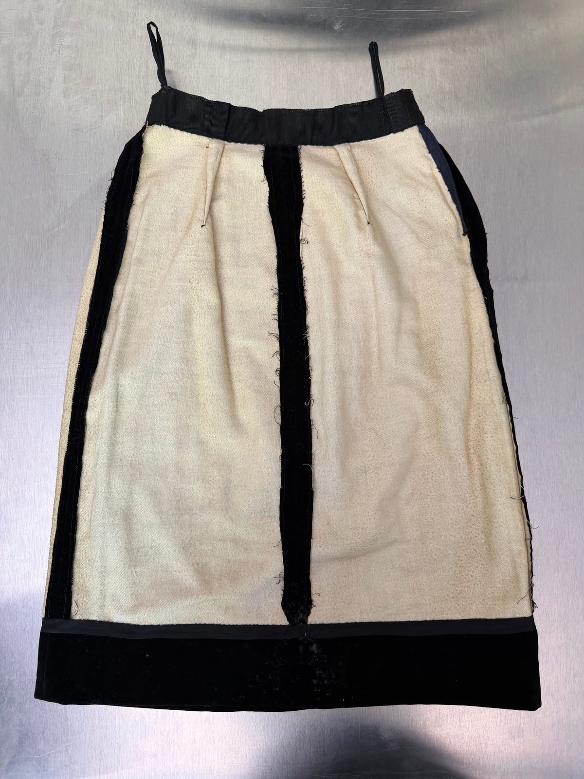 the black velvet skirt turned inside out, showing the cream interior lining and construction seams