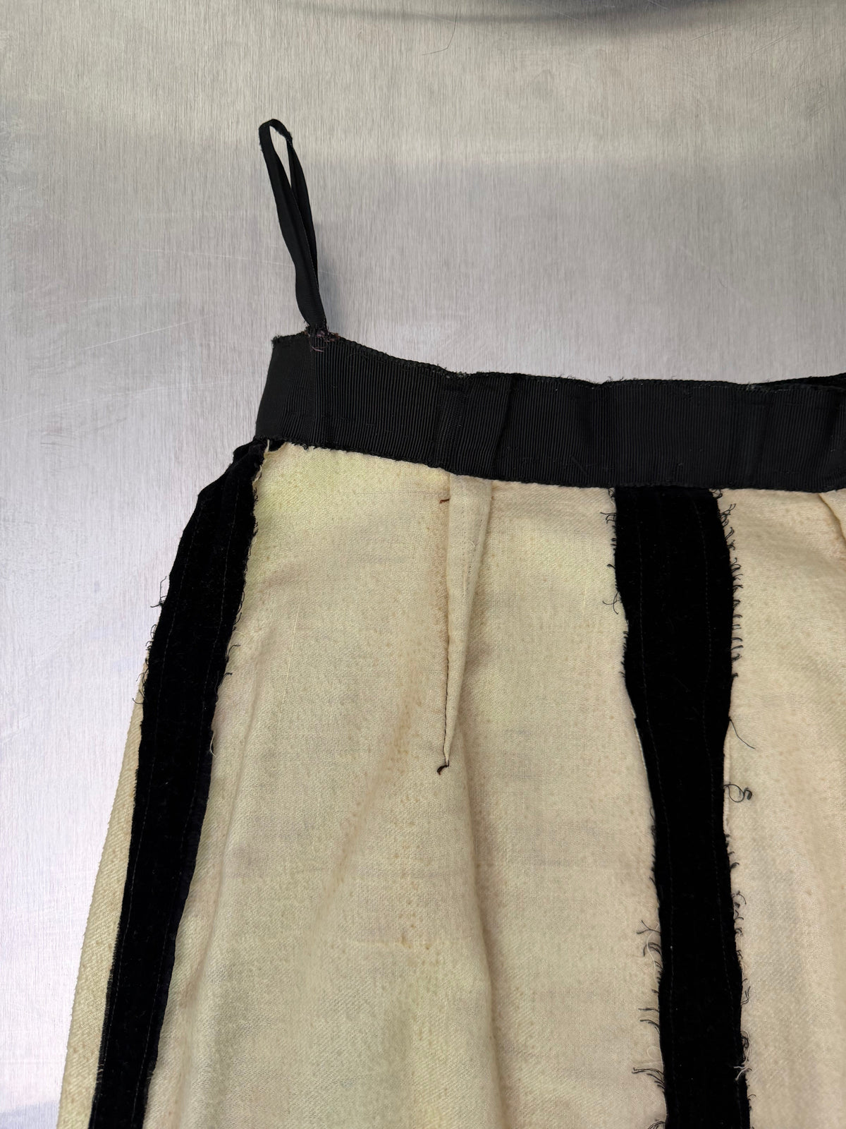 close-up of the black velvet skirt's interior, showing the elasticized waistband and lining seam