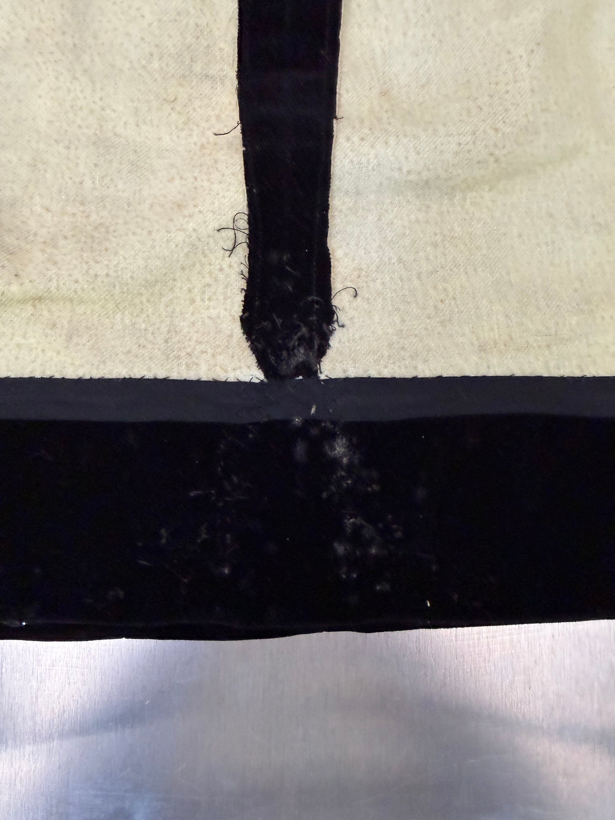 extreme close-up of a seam on the black velvet skirt's lining