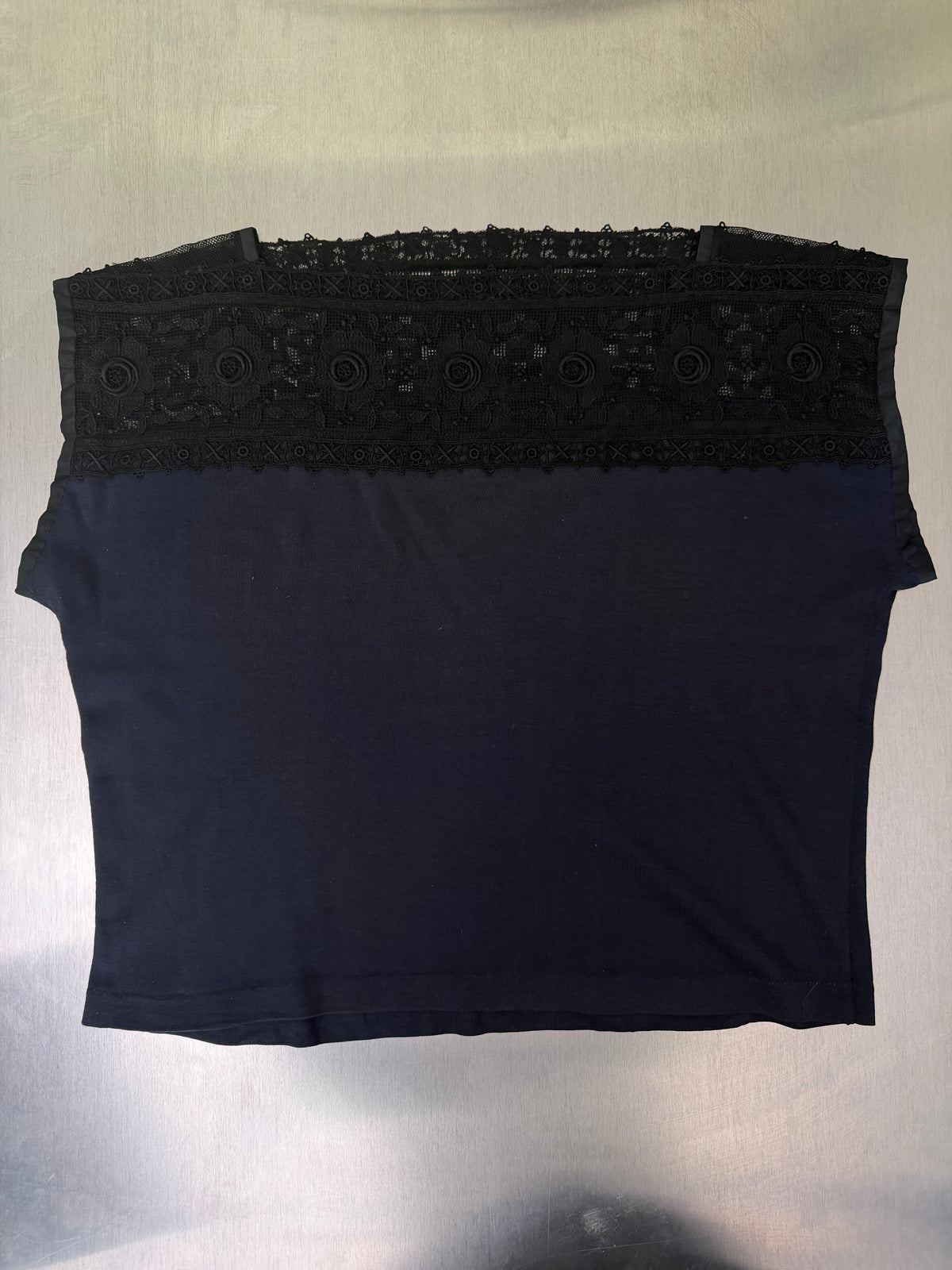black jersey top with black lace yoke, laid flat, front view