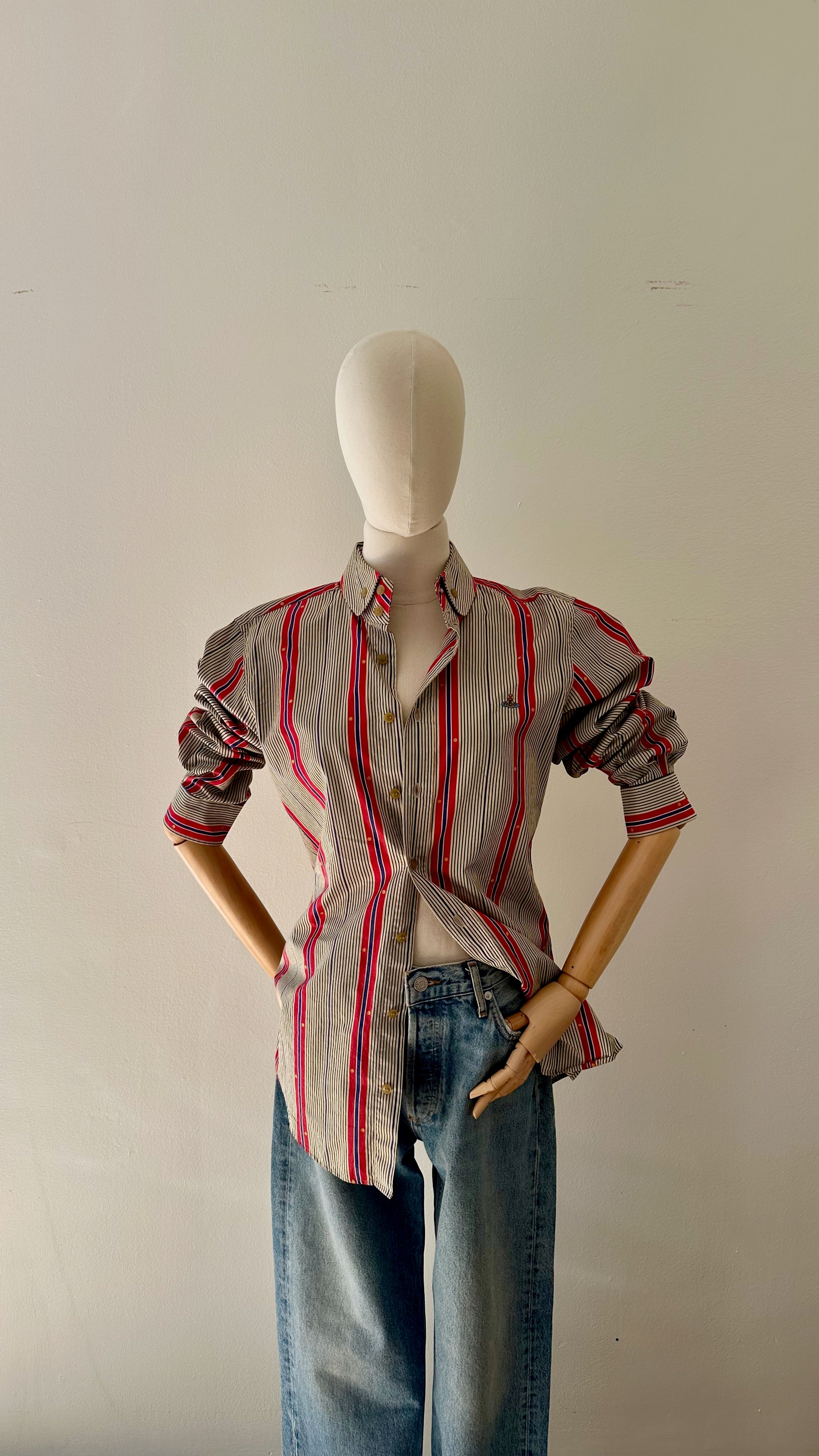Vintage Vivienne Westwood main label striped cotton button-down shirt styled with wide leg denim jeans, sleeves pushed up, worn open at chest, on articulated dress form.
