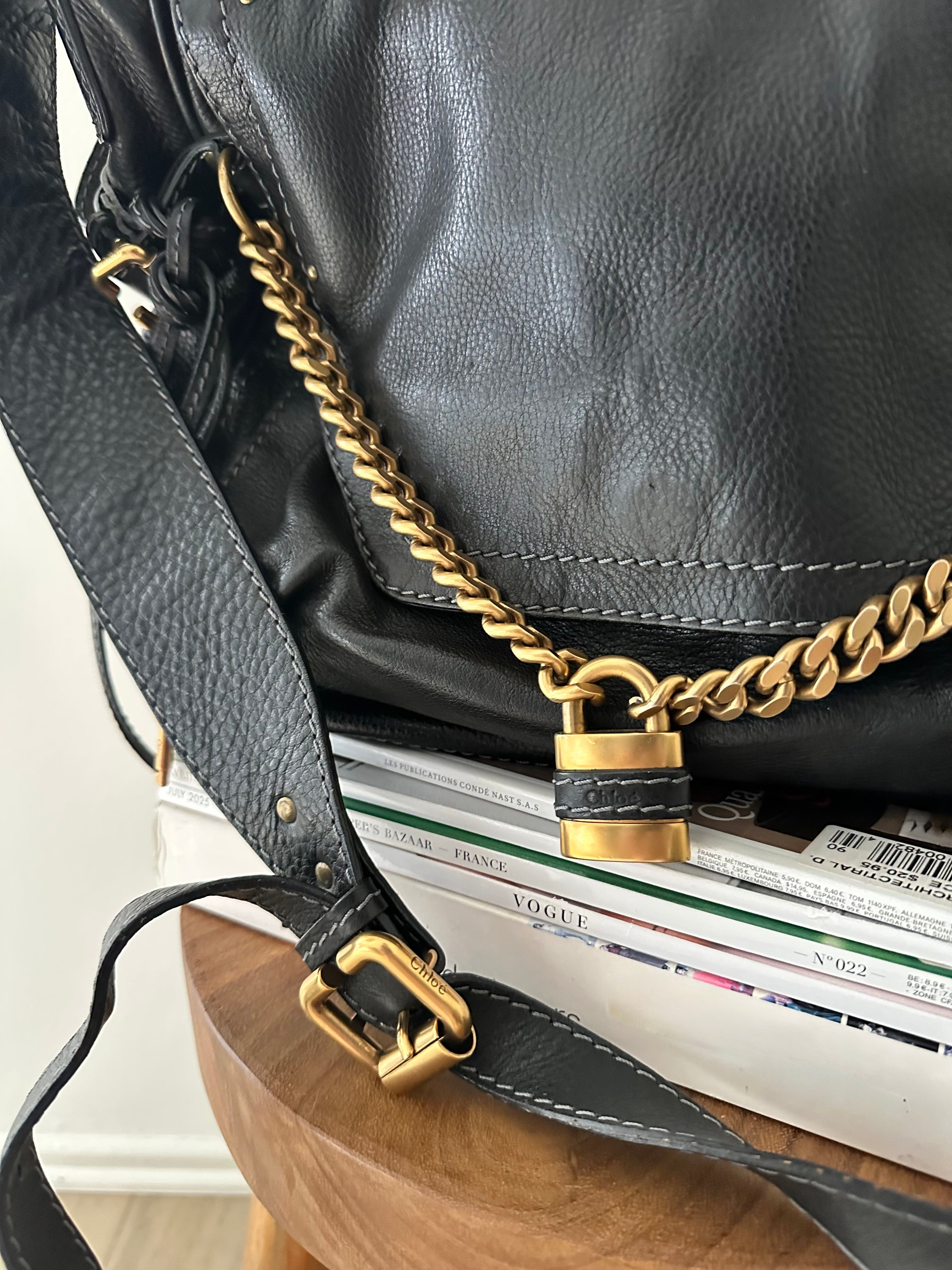 Close-up of antique gold chain strap and brass padlock on vintage Chloé Paddington Capsule bag, black leather, circa 2005