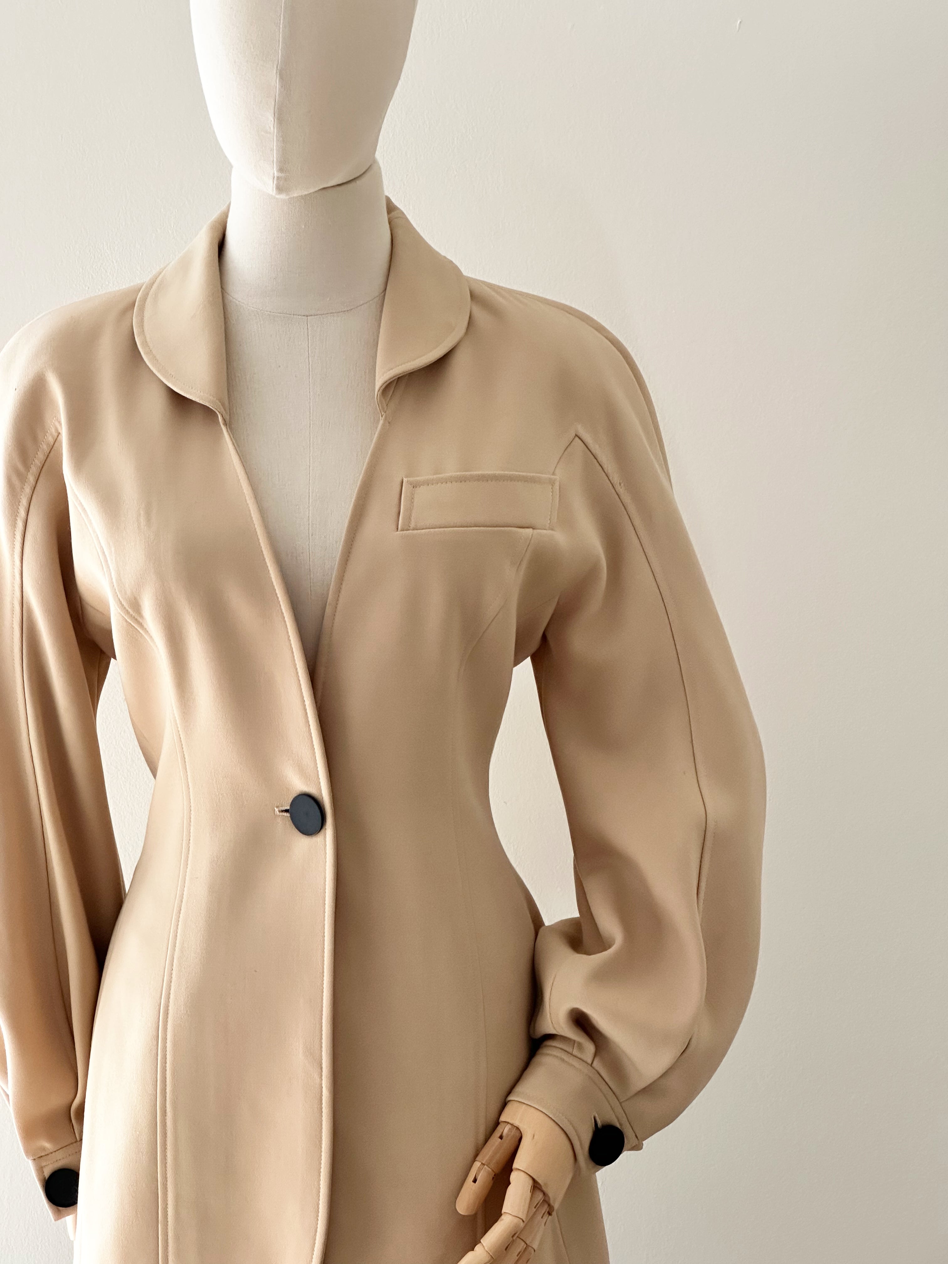 Beige jacket on a mannequin against a neutral background